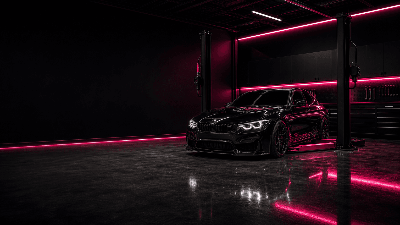 Black BMW on a low vehicle hoist inside a premium performance garage